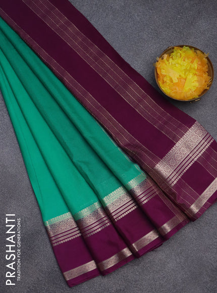 Semi crepe saree teal green and purple with plain body and rettapet zari woven border