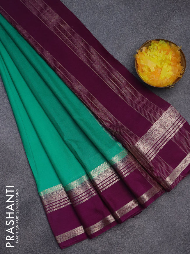 Semi crepe saree teal green and purple with plain body and rettapet zari woven border