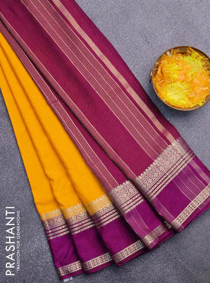 Semi crepe saree mango yellow and purple with plain body and rettapet zari woven border