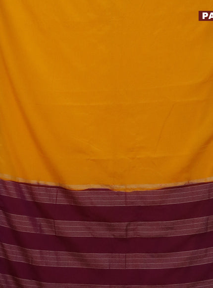 Semi crepe saree mango yellow and purple with plain body and rettapet zari woven border