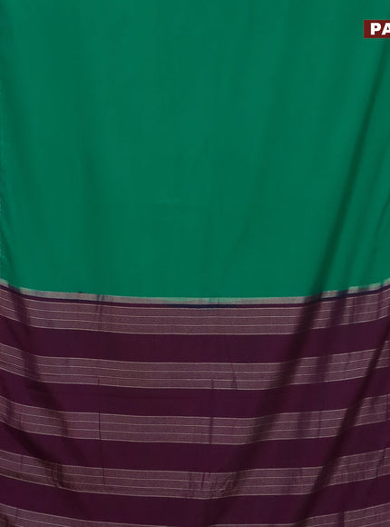 Semi crepe saree teal green and purple with plain body and rettapet zari woven border