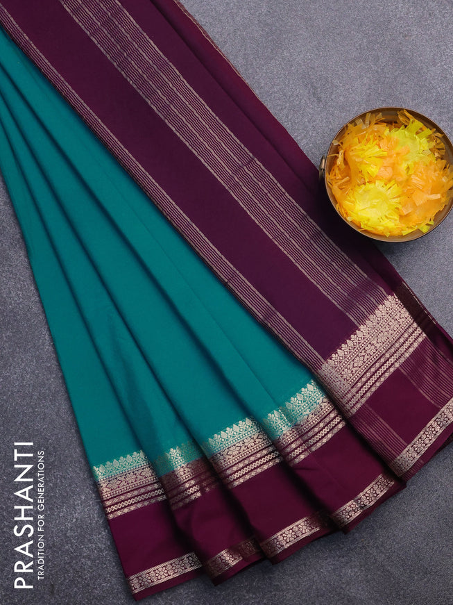 Semi crepe saree teal blue shade and purple with plain body and rettapet zari woven border