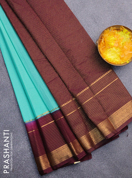 Semi crepe saree teal blue and wine shade with plain body and long zari woven border