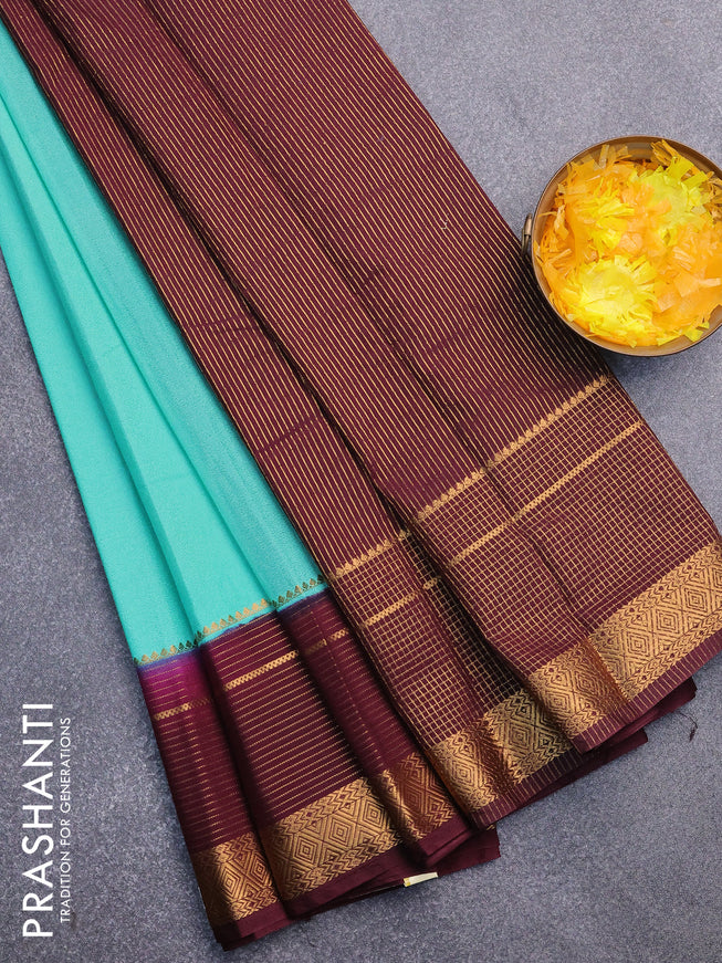 Semi crepe saree teal blue and wine shade with plain body and long zari woven border