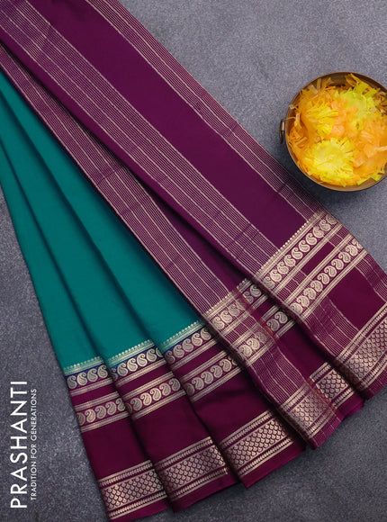 Semi crepe saree teal blue and purple with plain body and long rettapet zari woven border