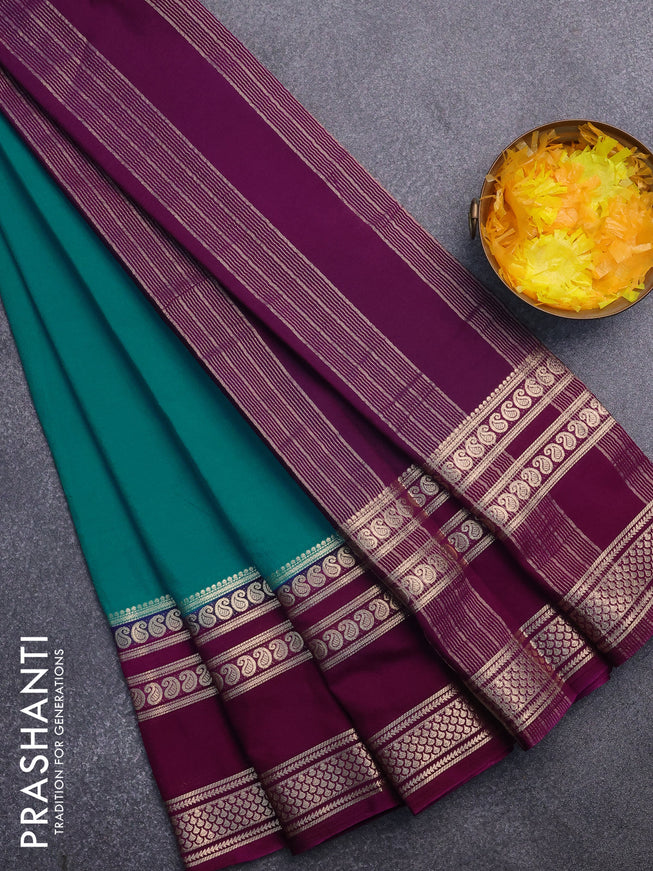 Semi crepe saree teal blue and purple with plain body and long rettapet zari woven border