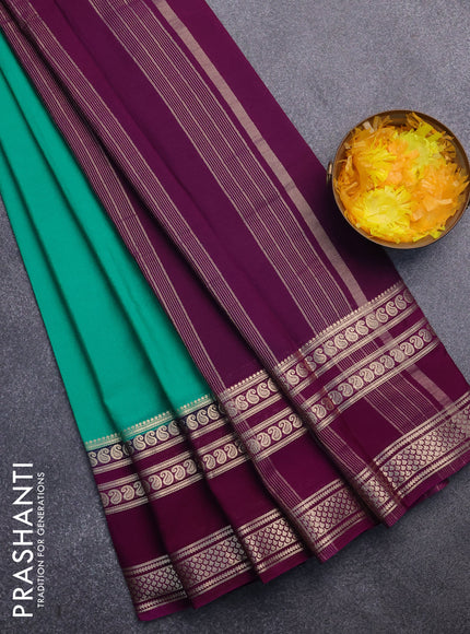 Semi crepe saree teal green and purple with plain body and long rettapet zari woven border