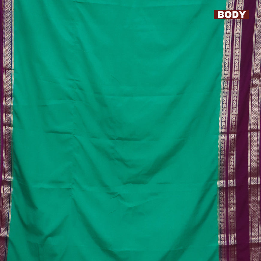 Semi crepe saree teal green and purple with plain body and long rettapet zari woven border