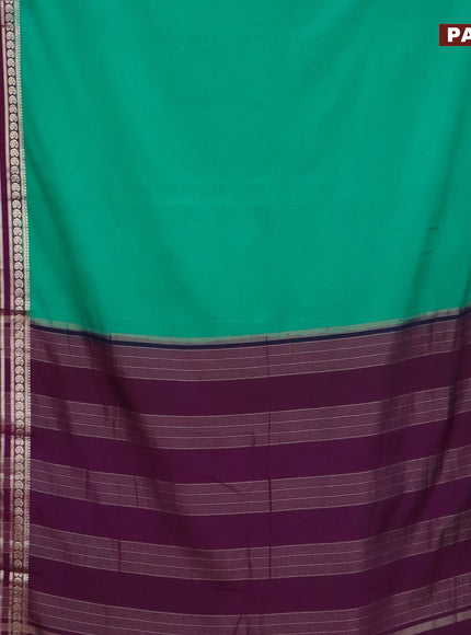 Semi crepe saree teal green and purple with plain body and long rettapet zari woven border