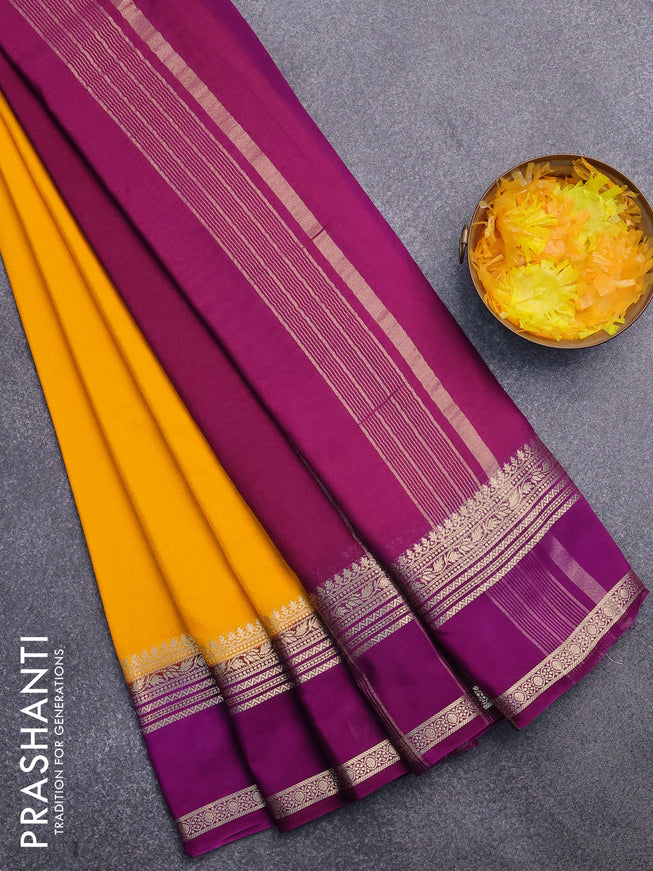 Semi crepe saree mango yellow and purple with plain body and rettapet zari woven border