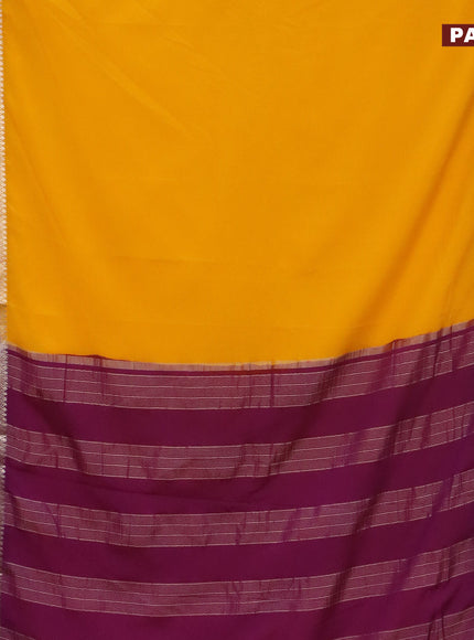 Semi crepe saree mango yellow and purple with plain body and rettapet zari woven border