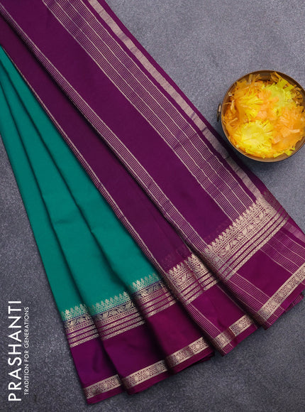 Semi crepe saree teal blue shade and purple with plain body and rettapet zari woven border