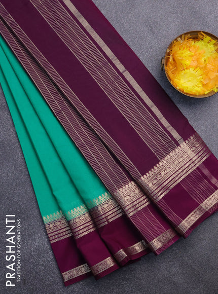 Semi crepe saree teal green and purple with plain body and rettapet zari woven border