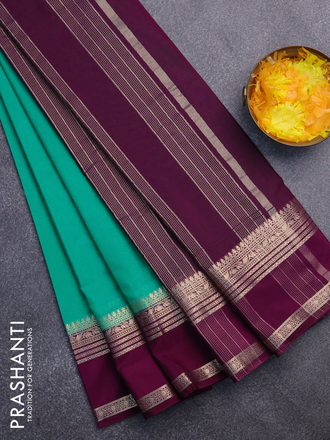 Semi crepe saree teal green and purple with plain body and rettapet zari woven border