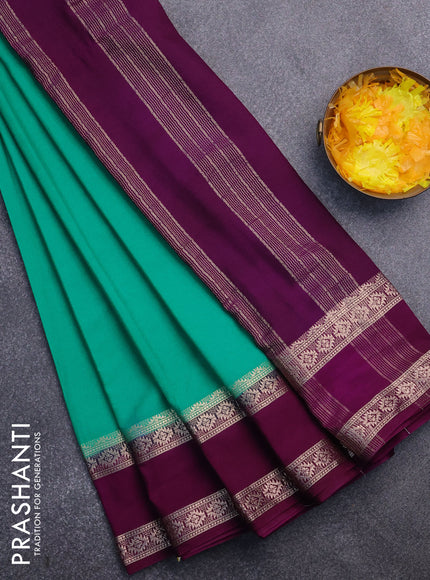 Semi crepe saree teal green and purple with plain body and rettapet zari woven border