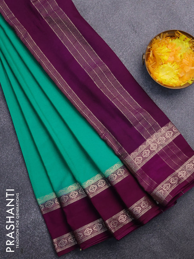 Semi crepe saree teal green and purple with plain body and rettapet zari woven border