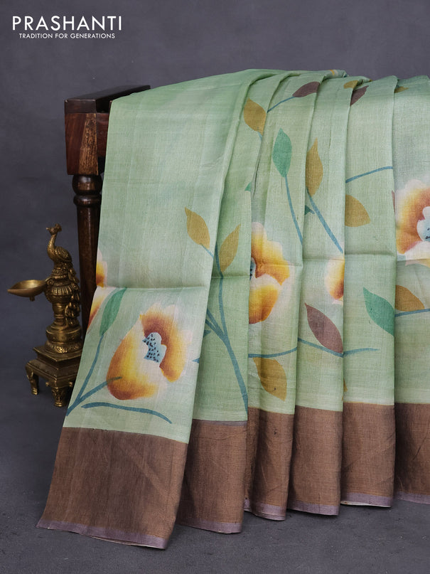 Pure tussar silk saree pastel green and dark grey with allover floral hand painted prints and zari woven border