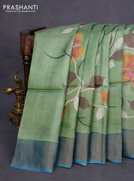 Pure tussar silk saree pastel green and peacock blue with allover floral hand painted prints and zari woven border