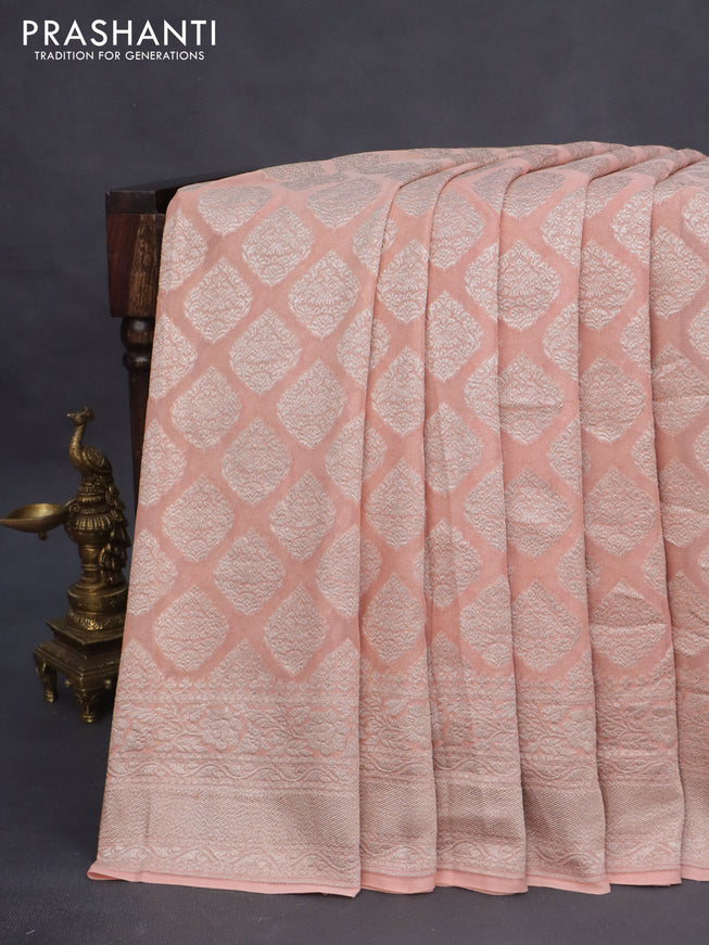 Banarasi georgette saree pastel peach orange with allover thread & zari woven butta weaves and woven border