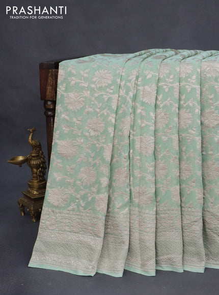 Banarasi georgette saree pastel green shade with allover thread & zari weaves and woven border