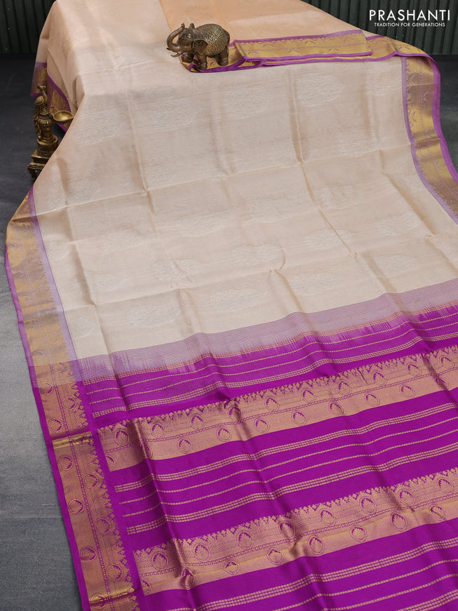 Silk cotton saree sandal and purple with allover self emboss & jacquard and zari woven border