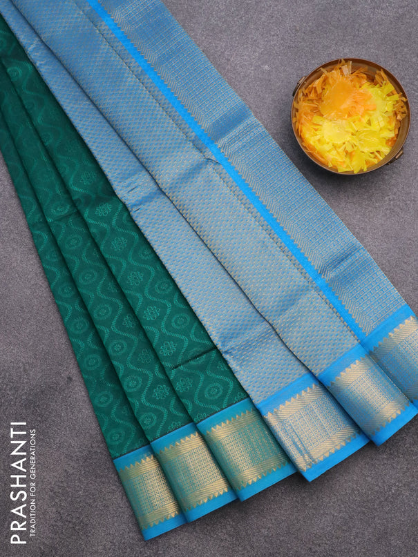 Silk cotton saree peacock green and cs blue with allover self emboss & jacquard and zari woven border