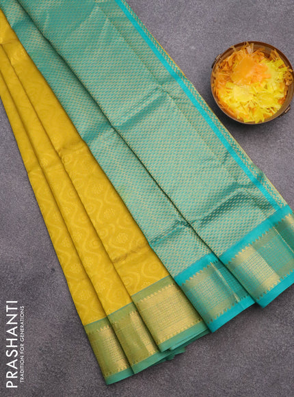 Silk cotton saree mustard yellow and teal green shade with allover self emboss & jacquard and zari woven border