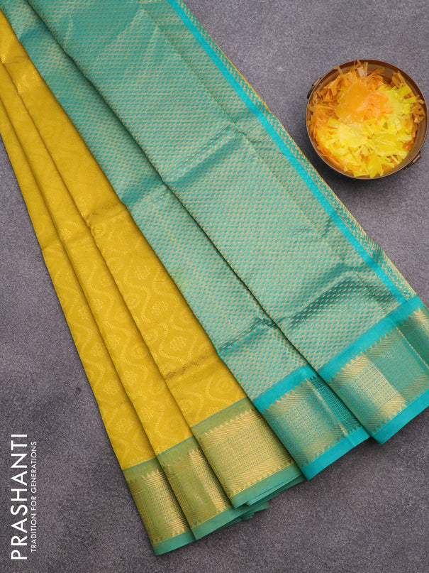 Silk cotton saree mustard yellow and teal green shade with allover self emboss & jacquard and zari woven border