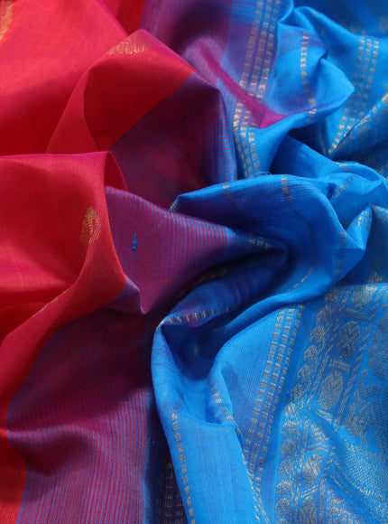 Silk cotton saree dual shade of pinkish orange and cs blue with zari woven buttas and annam zari woven border