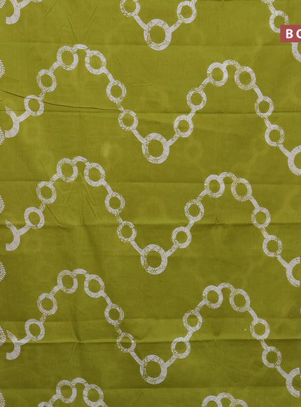 Jaipur cotton saree lime green and off white with allover batik prints and printed border