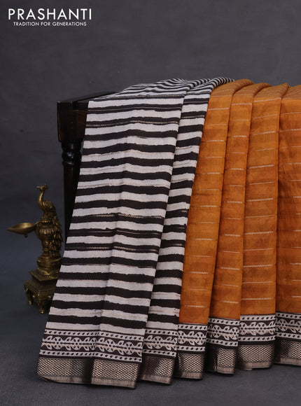 Assam partly silk saree dark mustard and black with digital prints & zari weaves and zari woven border