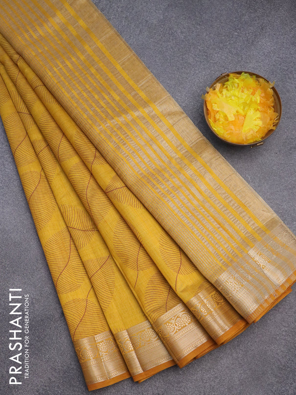 Semi raw silk saree mustard yellow with allover leaf prints and zari woven border