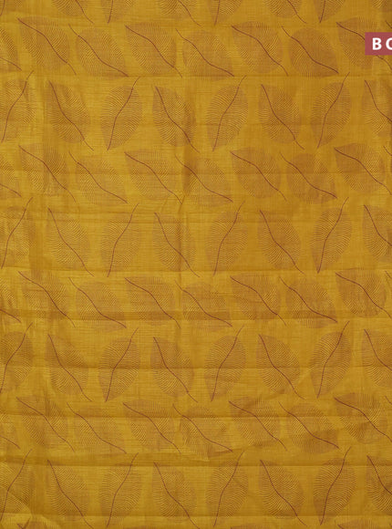 Semi raw silk saree mustard yellow with allover leaf prints and zari woven border