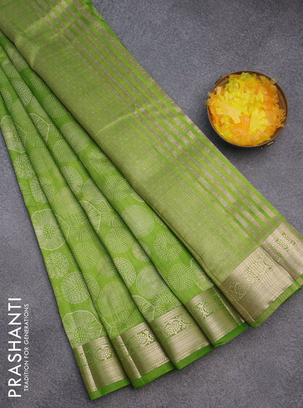 Semi raw silk saree light green with allover prints and zari woven border