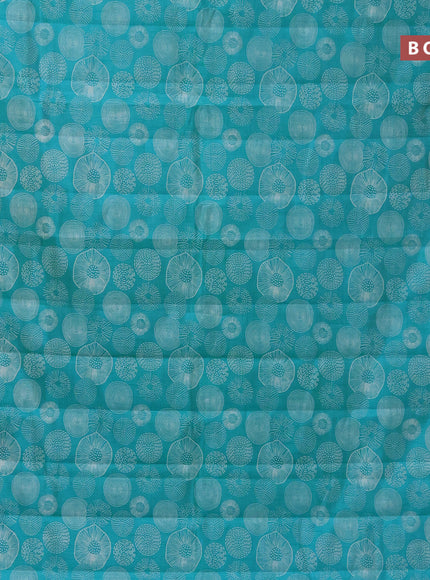 Semi raw silk saree teal blue with allover prints and zari woven border