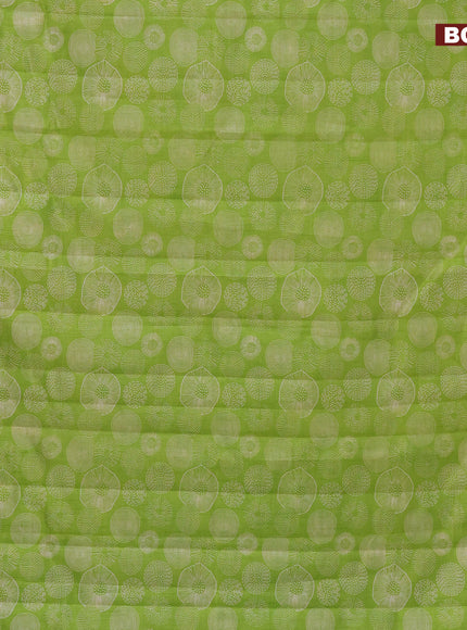 Semi raw silk saree light green with allover prints and zari woven border