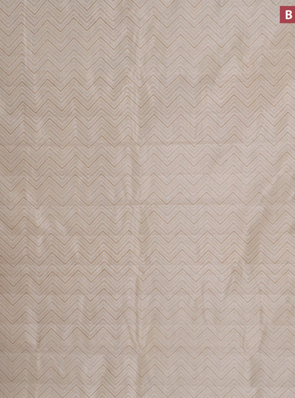 Semi raw silk saree cream with allover zig zag prints and zari woven border