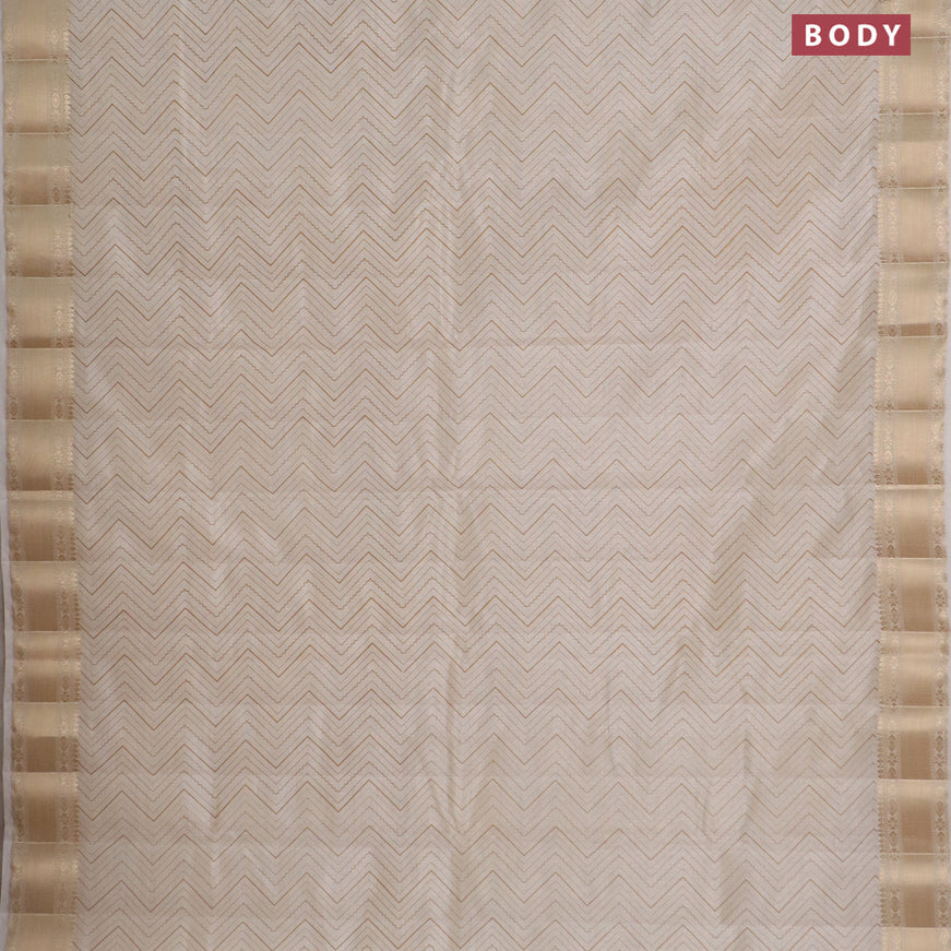 Semi raw silk saree cream with allover zig zag prints and zari woven border