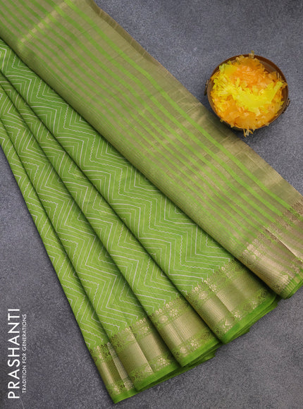 Semi raw silk saree light green with allover zig zag prints and zari woven border