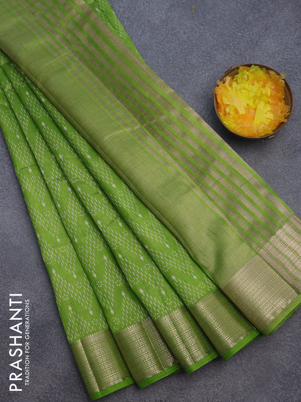 Semi raw silk saree light green with allover prints and zari woven border