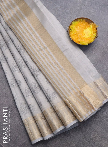 Semi raw silk saree pastel grey with butta prints and zari woven border