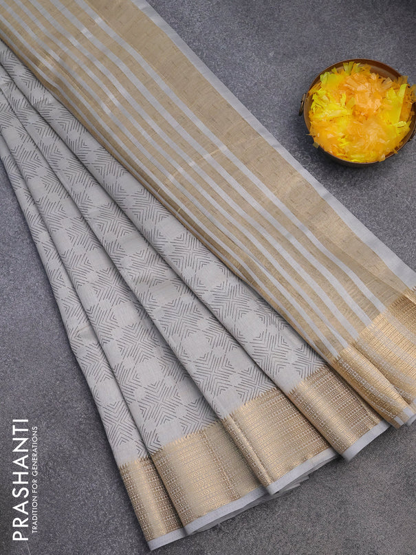 Semi raw silk saree pastel grey with allover prints and zari woven border