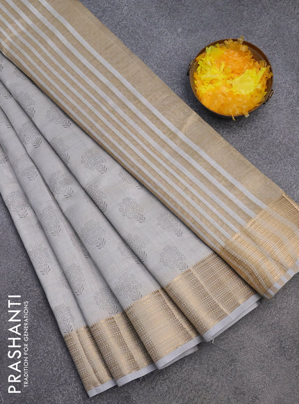 Semi raw silk saree pastel grey with floral butta prints and zari woven border