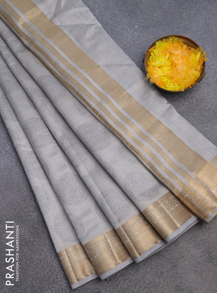 Semi raw silk saree pastel grey with butta prints and zari woven border