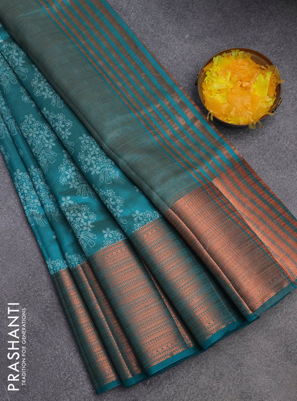 Semi raw silk saree teal green shade with allover floral butta prints and long copper zari woven border