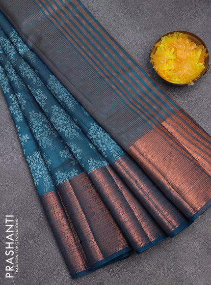 Semi raw silk saree cs blue with allover floral butta prints and long copper zari woven border