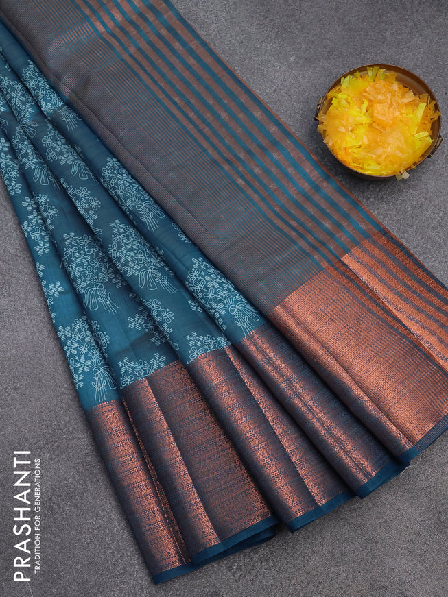 Semi raw silk saree cs blue with allover floral butta prints and long copper zari woven border