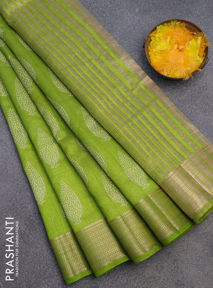 Semi raw silk saree light green with allover leaf prints and zari woven border