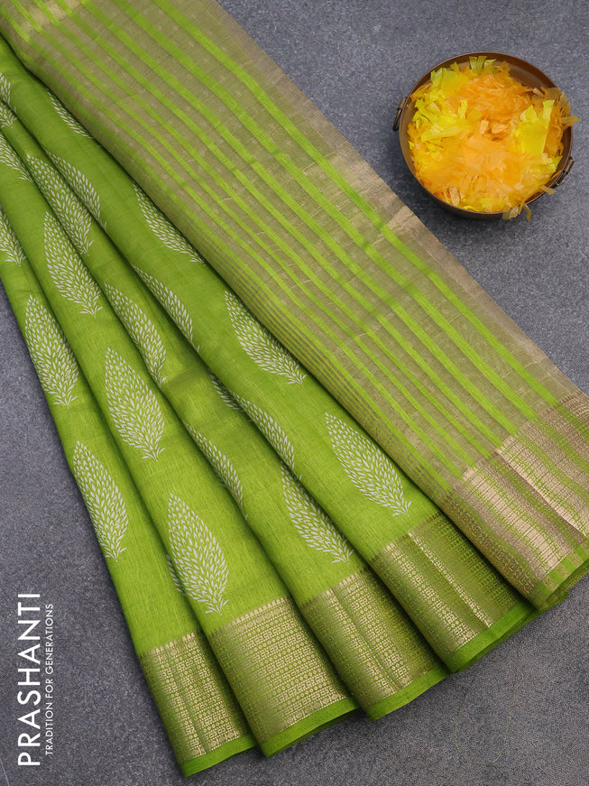 Semi raw silk saree light green with allover leaf prints and zari woven border