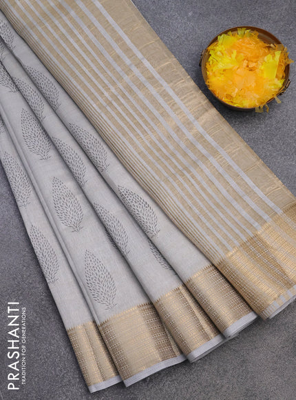 Semi raw silk saree pastel grey with allover leaf prints and zari woven border